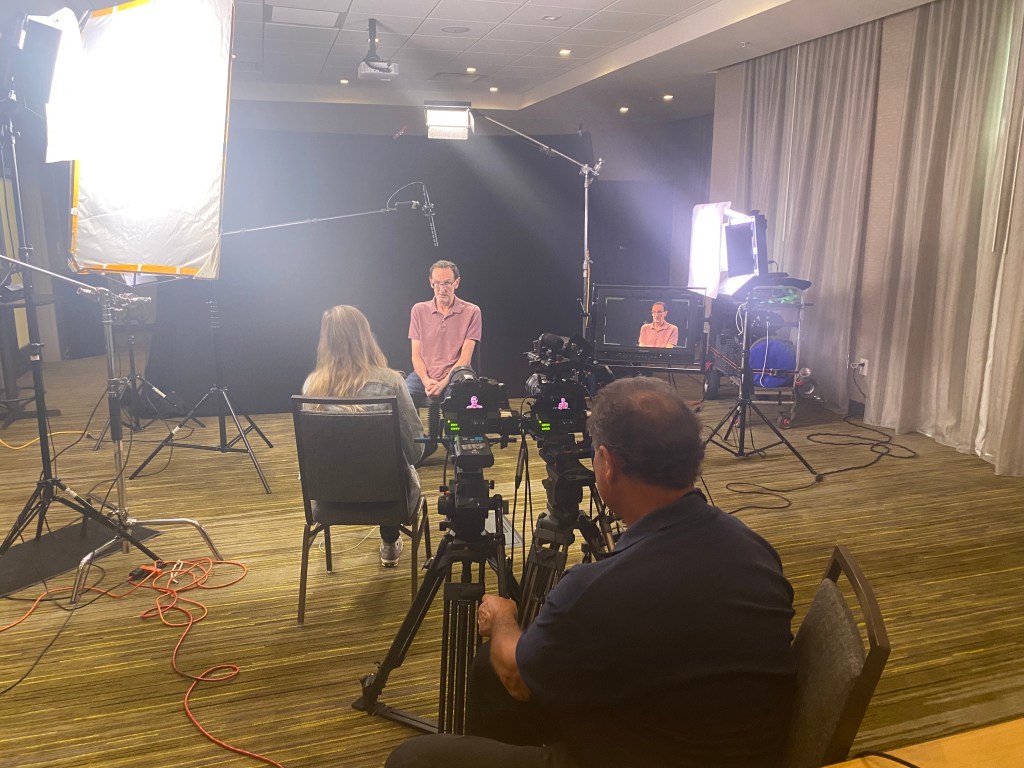 Video taping interviews on location for Warner television