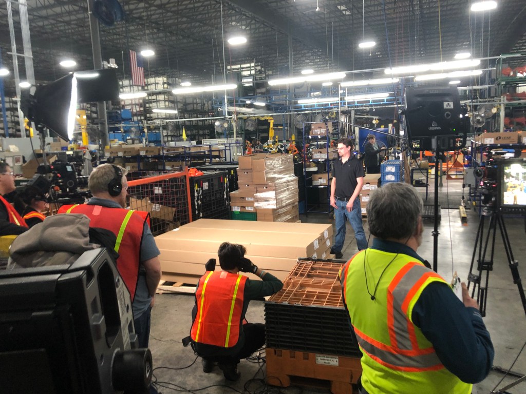Video crew recording at a remote industrial manufacturing plant.